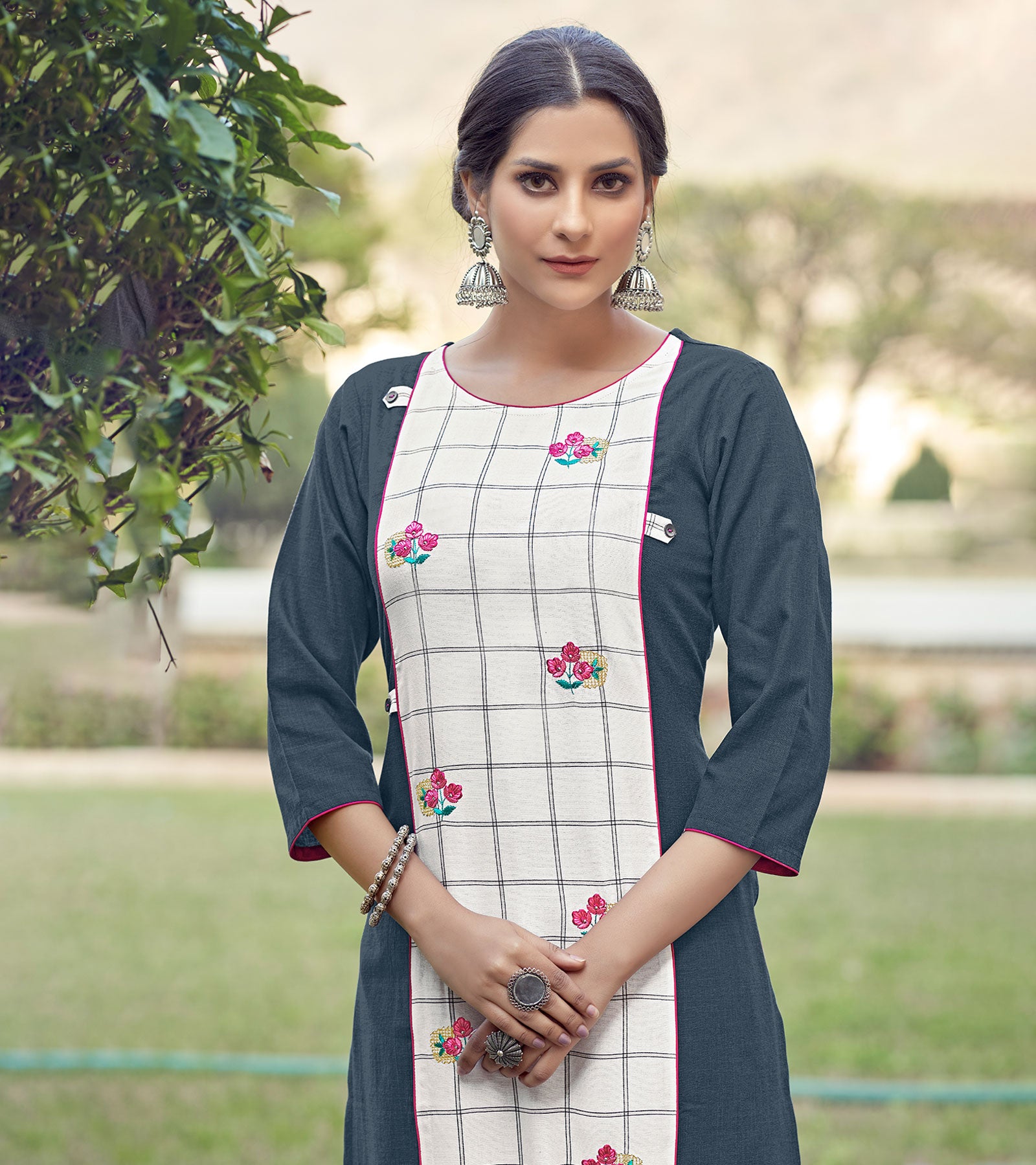 Laxmipati Rayon Cross And Swiss Slub Shadow Grey And White Checks Kurti With Two Fabrics By Giving All Over Grading Butta With Different Princess Lines , Fancy Yoke , Classy Necklines And Sleeve With Comfy Cuff.